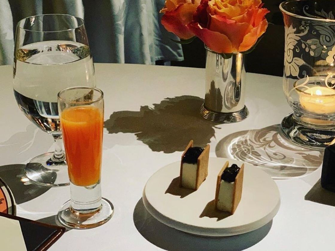 A restaurant table set with ceramic pedestals and desserts