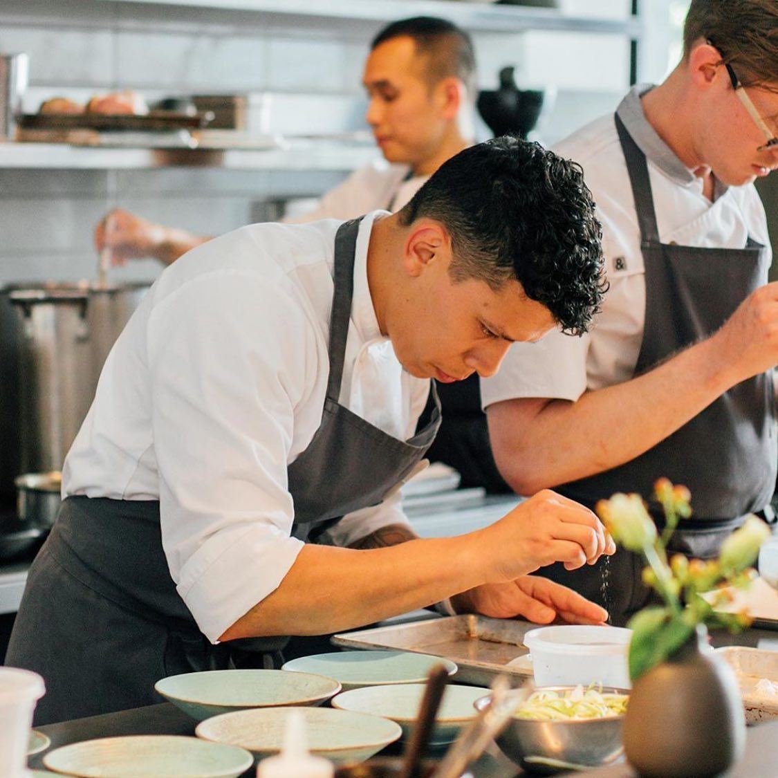 Chefs plating dishes during restaurant service