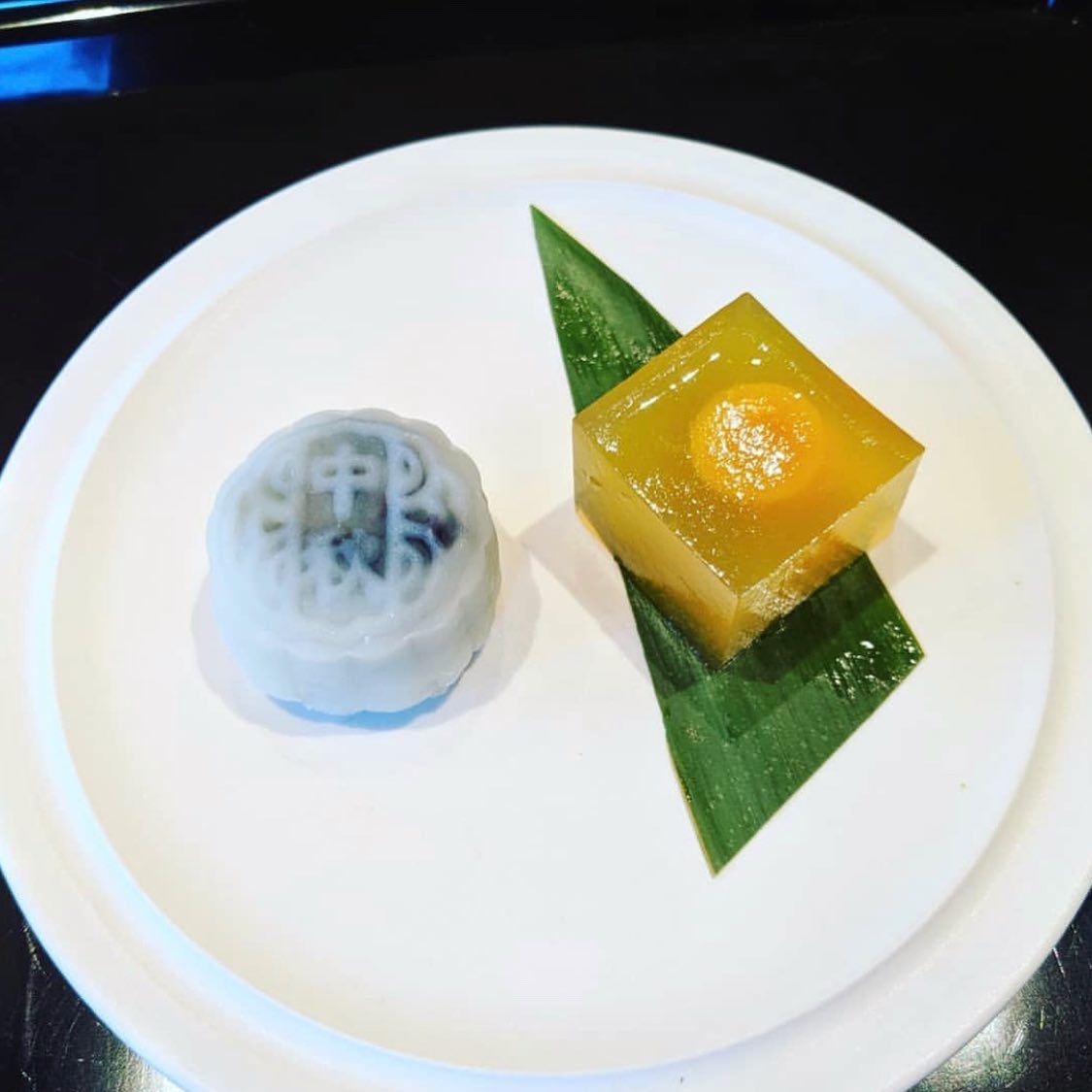 A small plated course centered on a pale ceramic dish
