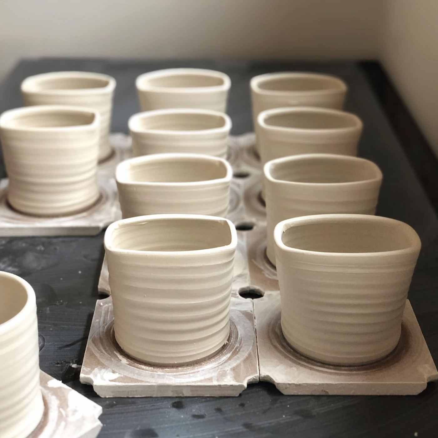 Rows of new ceramic cracker-container forms in the studio